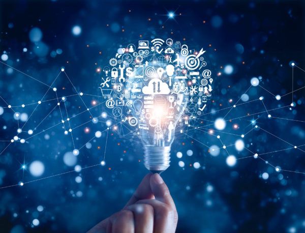 Hand holding light bulb and business digital marketing innovation technology icons on network connection, blue background Hand holding light bulb and business digital marketing innovation technology icons on network connection, blue background