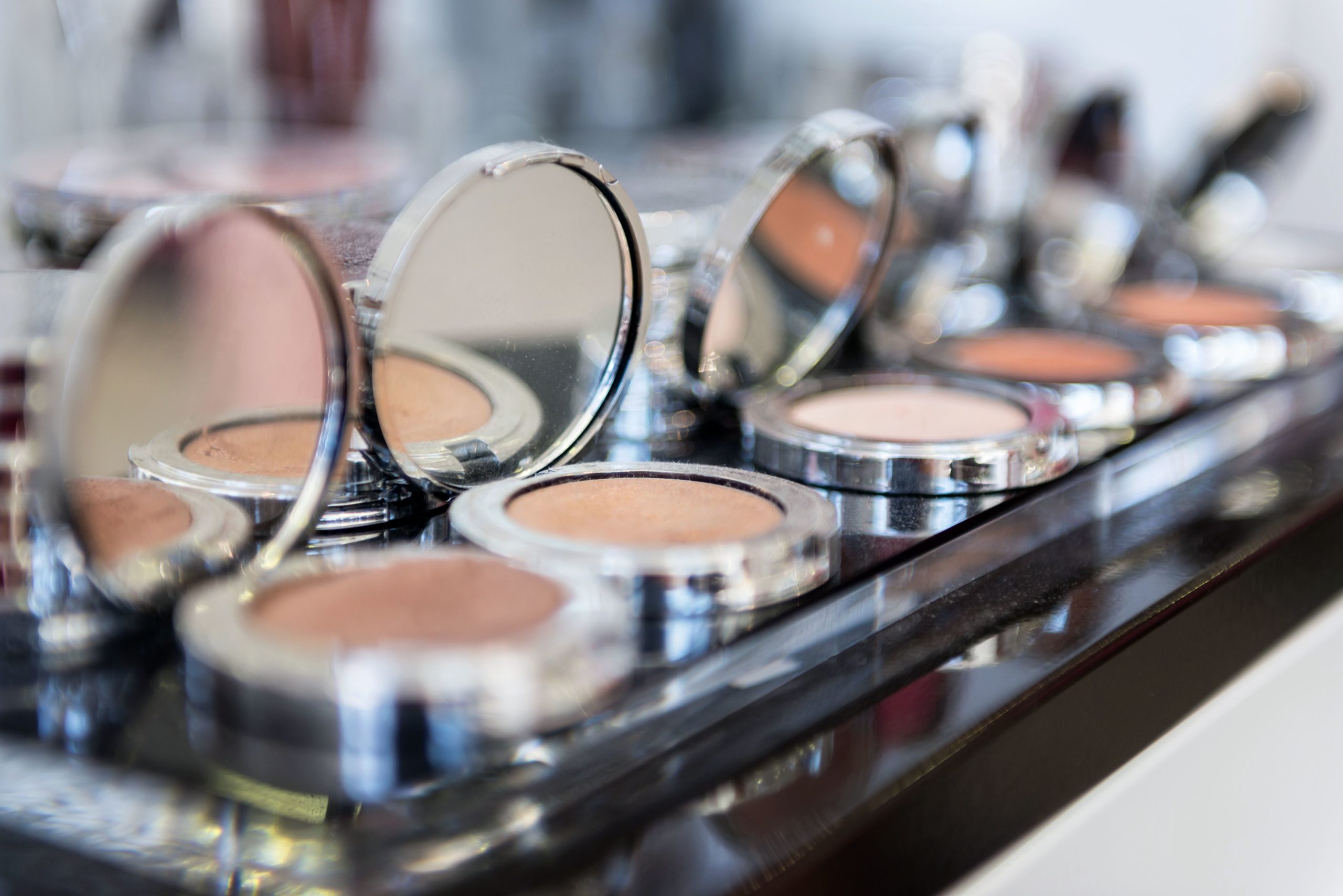 Group of compact make-up powders Horizontal color image of group of compact powders arranged in a row.
